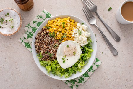 Photo for Quinoa breakfast bowl with lettuce, fried egg, feta cheese and corn - Royalty Free Image