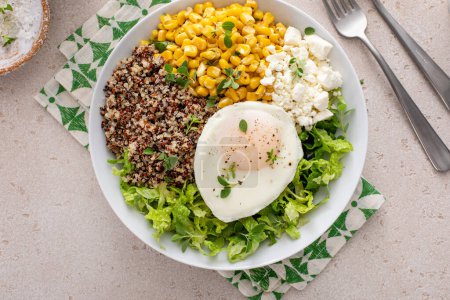 Photo for Quinoa breakfast bowl with lettuce, fried egg, feta cheese and corn - Royalty Free Image