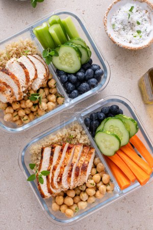 Meal prep containers with healthy high protein food prepped, cooked quinoa, chickpeas and eggs