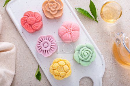 Traditional snow skin mooncakes for a Chinese Mid-Autumn Festival or Moon festival served with tea