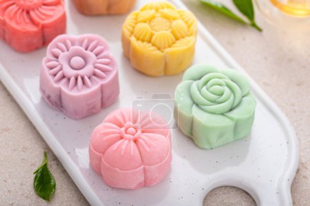 Traditional snow skin mooncakes for a Chinese Mid-Autumn Festival or Moon festival served with tea