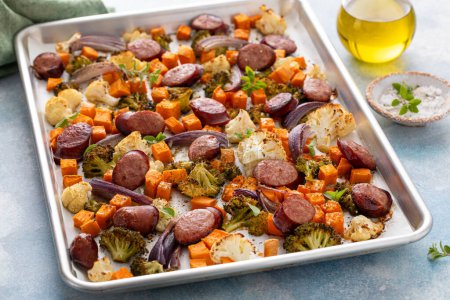 Photo for Sheet pan dinner with sausage and vegetables roasted and ready to eat with broccoli and cauliflower - Royalty Free Image