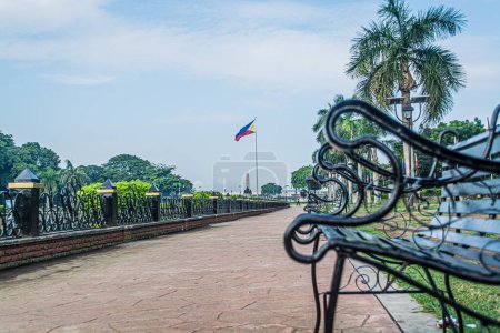 Photo for Rizal Park, Manila, Philippines July 2, 2014: The benches along the path around the water fountain at the Rizal Park in Manila, Philippines - Royalty Free Image