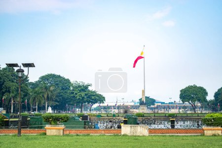 Photo for Rizal Park, Manila, Philippines July 2, 2014: The Philippine flag at the background of a grassy field at the Rizal Park in Manila, Philippines - Royalty Free Image