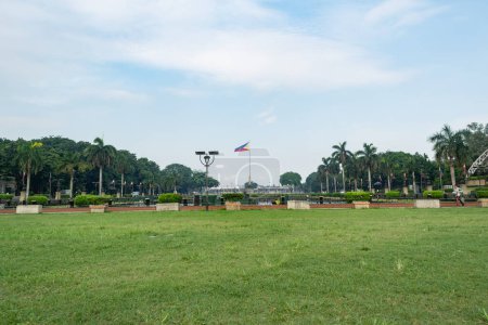 Photo for Rizal Park, Manila, Philippines July 2, 2014: The Philippine flag at the background of the grassy field at the Rizal Park in Manila, Philippines - Royalty Free Image