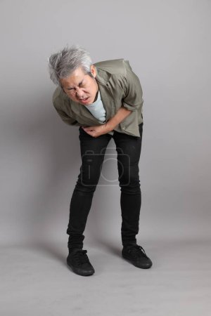 Photo for The 40s Asian man with smart casual clothes standing on the grey background. - Royalty Free Image