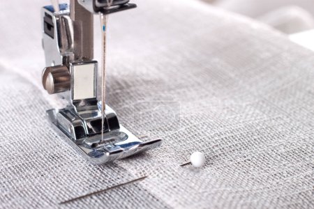 Photo for Modern sewing machine presser foot with linen fabric and thread, closeup, copy space. Sewing process clothes, curtains, upholstery. Business, hobby, handmade, zero waste, recycling, repair concept - Royalty Free Image