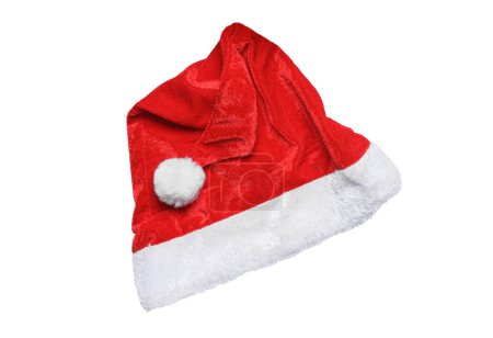 Téléchargez les photos : Chapeau du Père Noël isolé sur fond blanc. Élément design, symbole traditionnel de Noël. Chapeau Santa en velours rouge, vue sur le dessus, couchage plat. - en image libre de droit