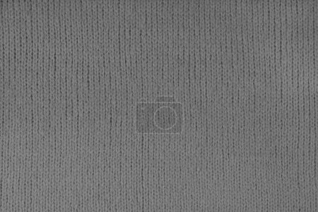 Gray knitted woolen jersey fabric, sweater, pullover texture background. Fabric abstract backdrop, cloth wallpaper