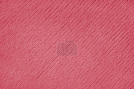 Red knitted woolen jersey fabric with diagonal weaving, sweater, pullover texture background. Fabric abstract backdrop, cloth wallpaper