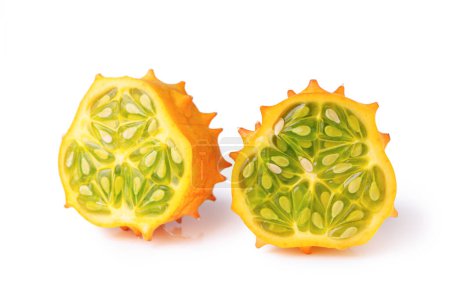 Kiwano fruit, green horned melon isolated on white background. Organic orange kiwano, African horned melon slices with green, jelly like inside with seeds close up.