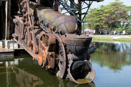 The last abandoned tin mining dredger during British colonial now display in Tanjung Tualang, Batu Gajah, Perak, Malaysia - Malayan Tin Dredging (MTD) introduced the first dredge in Batu Gajah since January 1913. Now open to all visitors. 