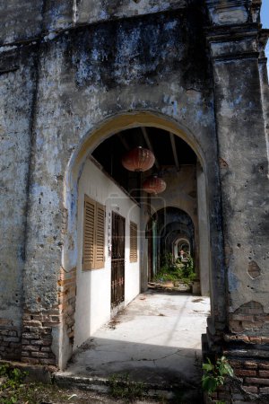 Dilapidated vintage corridor in the abandoned tin mining town of Jalan Papan in the outskirts of the city of Pusing, Perak, Malaysia - The forgotten heritage of Papan village with a hidden WWII history.