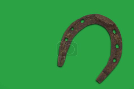 Foto de Lucky old horseshoe isolated green white. Horizontal St Patricks day theme poster, greeting cards, headers, website and app - Imagen libre de derechos