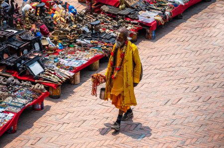 Photo for Kathmandu, Nepal - Apr 17, 2023: A Sadhu or Saddhu, a holy person in Hinduism, Buddhism, and Jainism, walking in a local market in Kathmandu, Nepal - Royalty Free Image