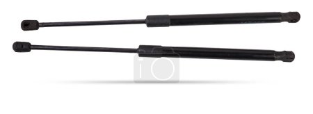 A pair of black metal hood shock absorbers with chrome elements - detail of a car mechanism on a white isolated background. Spare parts for body repair.