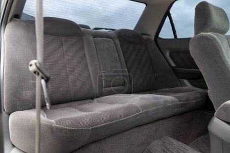 Photo for Close-up on rear seats with velours fabric upholstery in the interior of an old car in gray after dry cleaning. Auto service industry. - Royalty Free Image