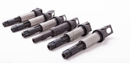 Six ignition coils for an internal combustion engine of a car during repair and service on a white isolated background. Spare parts catalog.