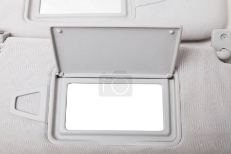 Sun visor with a mirror made of light gray plastic on a white background in a photo studio. Spare part of the car interior for replacement in a car service or for sale on auto dismantling.