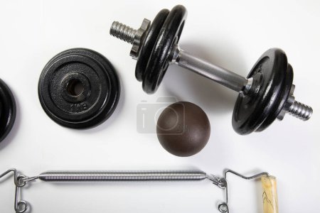 Weights and exercise equipment are arranged in a studio setting, ready for fitness routines and workouts.