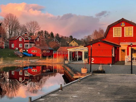 Photo for Sunset over Grisslehamn marina and some old houses during a early summer evening. Sweden - Royalty Free Image