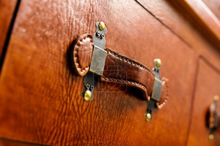 Close up of chest's leather handle 