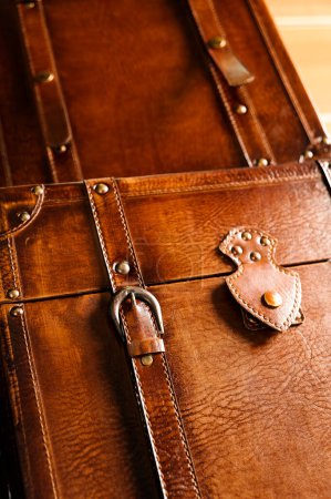 Close up of a vintage leather chest underneath another  