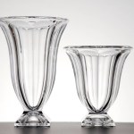 Pair of tulip shaped glass vases of different hights, isolated
