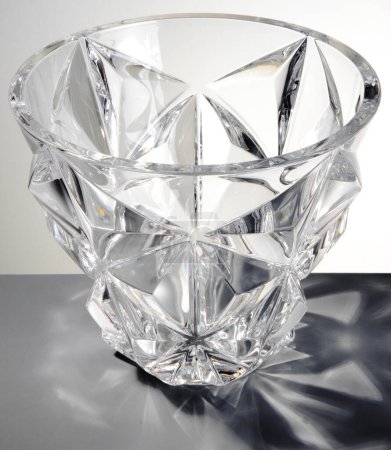 Pair of transparent glass vases with edges, isolated