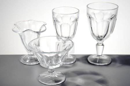 Set of four ice cream glasses of different hights and shapes, isolated