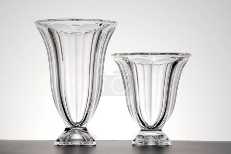 Pair of tulip shaped glass vases of different hights, isolated