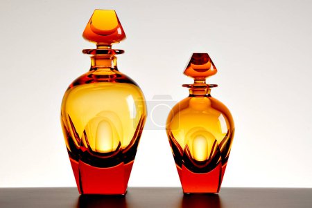 Pair of orange liquor glass bottles, isolated