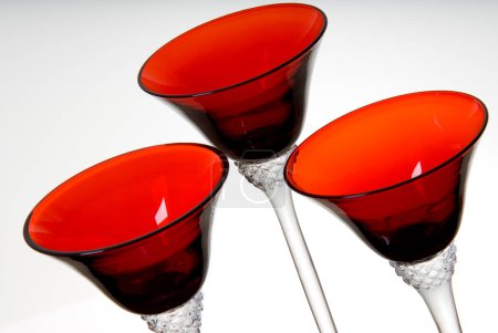 Detail of set of three martini glasses with red cup, isolated
