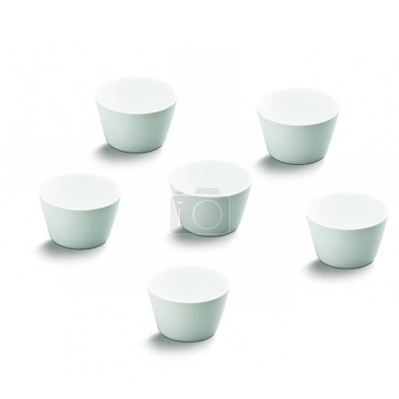 Set of six simple white empty ceramic cone shaped bowls, isolated 
