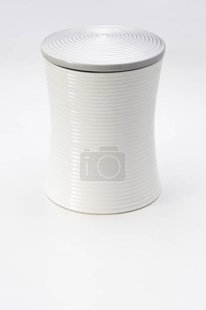 Tall white ceramic container, hourglass shaped, isolated on white