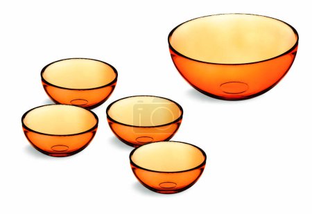 Photo for Kit with one large orange glass  bowl and 4 smaller bowls, isolated - Royalty Free Image