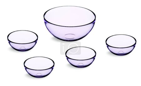 Kit with one large purple glass bowl and 4 smaller bowls, isolated