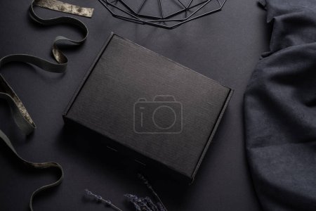 Photo for Black cardboard package box on dark background - Royalty Free Image