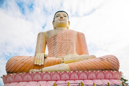 Photo for Aluthgama, Sri Lanka 07. 02. 2023 Huge - 48 m High - Sitting Buddha Statue in Kande Viharaya Temple in Aluthgama near Popular Tourist Center Bentota and Beruwala against blue sky - Royalty Free Image