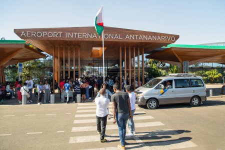 Photo for Ivato, Antananarivo, Madagascar 07.10. 2023 entrance Madagascar International Airport Ivato. people order taxi. cars are parked in parking lot in front of airport building - Royalty Free Image