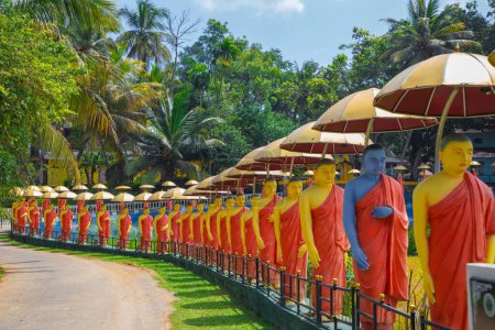 Photo for Dambulla, Sri Lanka 10 february 2023. row of Buddhist monk statues adjacent to Golden Temple at Dambulla central Sri Lanka. - Royalty Free Image