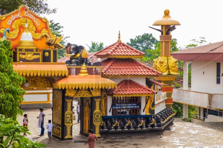 Photo for Aluthgama, Sri Lanka 07. 02. 2023 Statue in Kande Viharaya Temple in Aluthgama near Popular Tourist Center Bentota and Beruwala. beautiful curly buildings at entrance to Tempel - Royalty Free Image