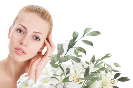 Photo for Beautiful woman with perfect skin and natural make-up with flowers - Royalty Free Image