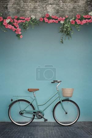 Photo for Composite image of a charming scene featuring a classic female bicycle leaning against a wall adorned with beautiful flowers. The wall offers a blank space, perfect for adding your own custom text or message. - Royalty Free Image