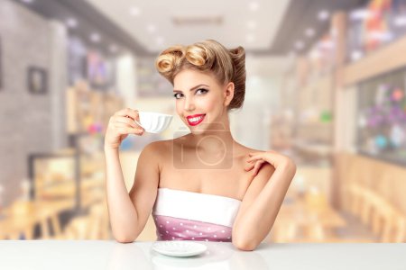Photo for A beautiful young woman with a 1950s American-style hairstyle, joyfully sipping tea. Perfect for retro-themed concepts and expressing timeless elegance. - Royalty Free Image