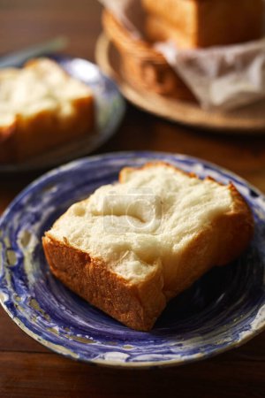 Foto de Panes frescos horneados en rodajas de trigo integral de cerca. pan blanco tostado de grano esponjoso textura shokupa - Imagen libre de derechos