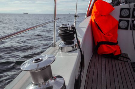 A life jacket lies on a modern boat next to the navigation system. Modern boat. Boat ride. Sailing yacht with navigation system. High quality photo