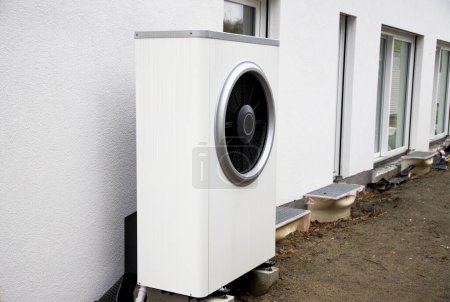heat pump in white outside of a building for renewable energy