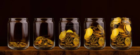 Photo for Gold coin in glass bottle on black scene, money and gold saving concept - Royalty Free Image