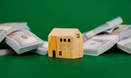 Photo for Model wooden house, toy wooden house with dollars, first house, real estate, home loan, home loan, rental house, renting a house financial income, salary, financial investment financial system savings concept - Royalty Free Image